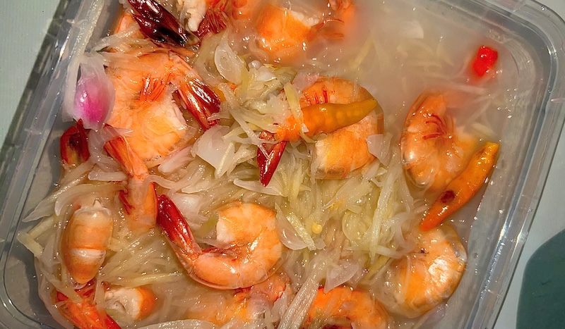 Southern-style pickled shrimp with onions and lemon slices
