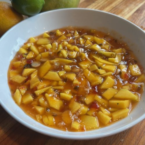 Fresh mango relish with citrus and pepper jelly in serving bowl