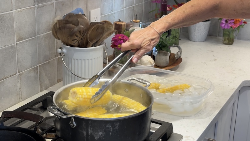 Sweet corn being blanched in boiling water before making salad
