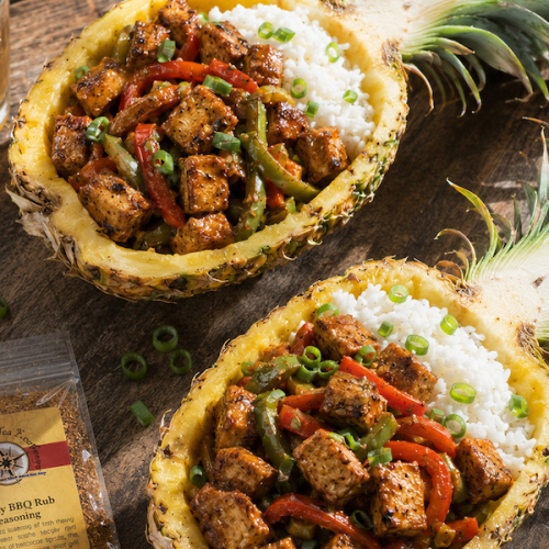 Honey BBQ chicken and peppers served in hollowed pineapple halves over jasmine rice