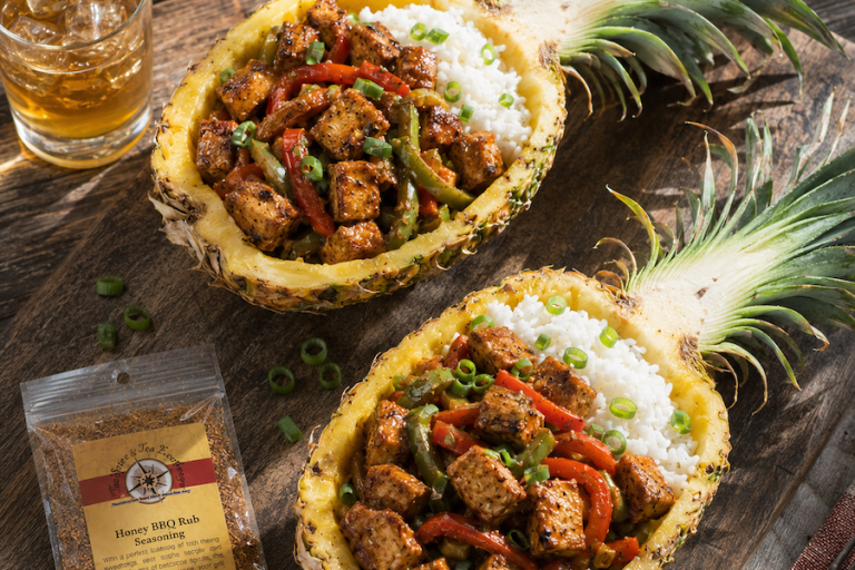 Honey BBQ chicken and peppers served in hollowed pineapple halves over jasmine rice