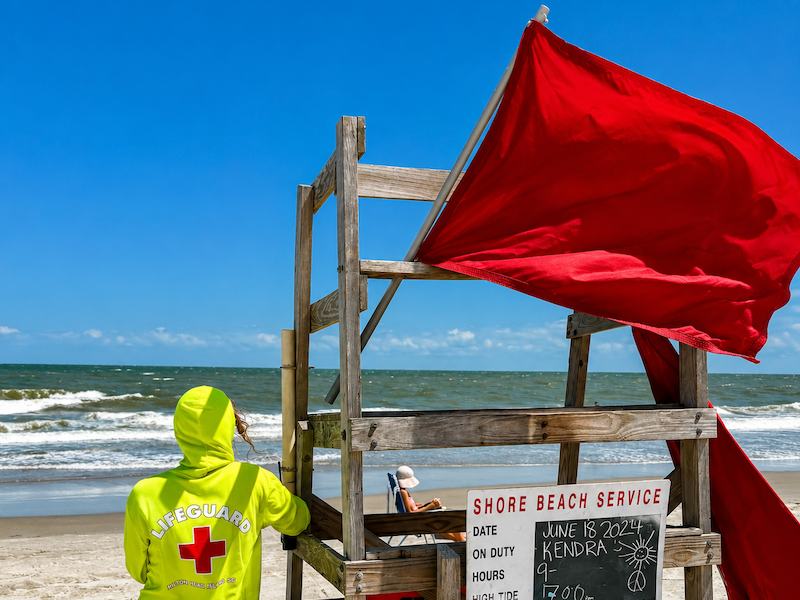 Red warning flag flying at Hilton Head beach indicating dangerous surf conditions