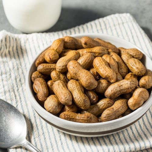 Bowl of homemade boiled peanuts on kitchen towel