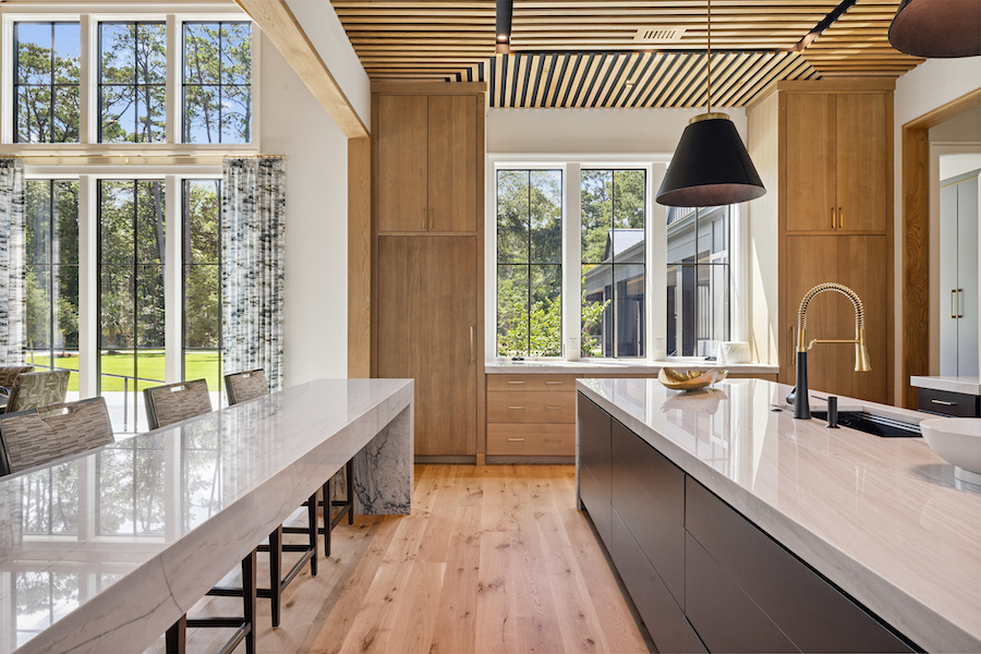 Two islands in Palmetto Bluff kitchen with hard surfaces from Distinctive Granite and Marble