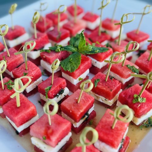 Watermelon and feta appetizer bites topped with mint and honey