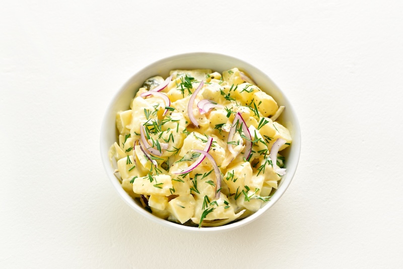 Traditional German potato salad with herbs and dressing