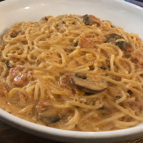 Bowl of creamy vermicelli pasta topped with Charlie Drawdy's signature sauce