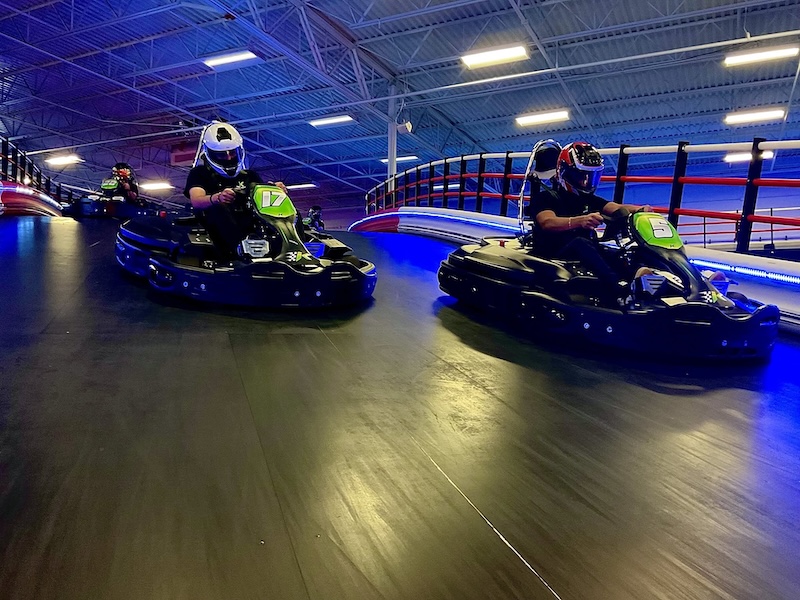 Friends racing electric go-karts at Indy Karting & Amusements in Bluffton.