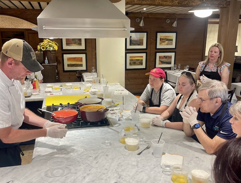 Friends learning Italian cooking techniques at Michael Anthony's Cooking School on Hilton Head Island.