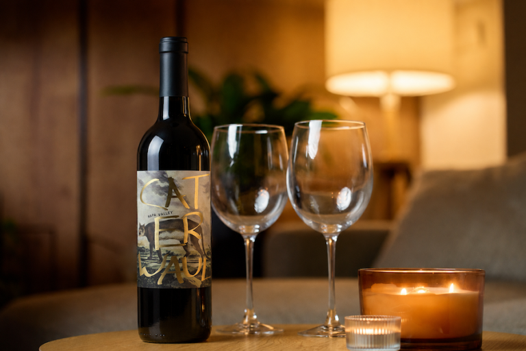 Bottle of Caterwaul Cabernet Sauvignon with wine glasses highlighting a Napa Valley Cabernet recommendation.