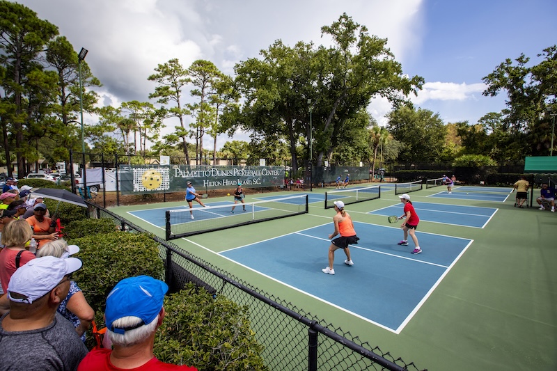 Friends playing pickleball at Palmetto Dunes Oceanfront Resort.