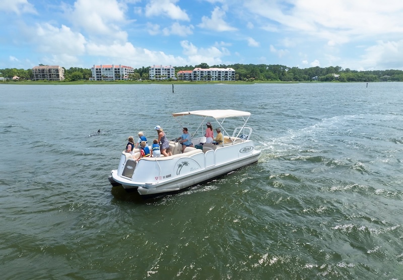 Friends enjoying a pontoon boat cruise from Shelter Cove Harbour & Marina.