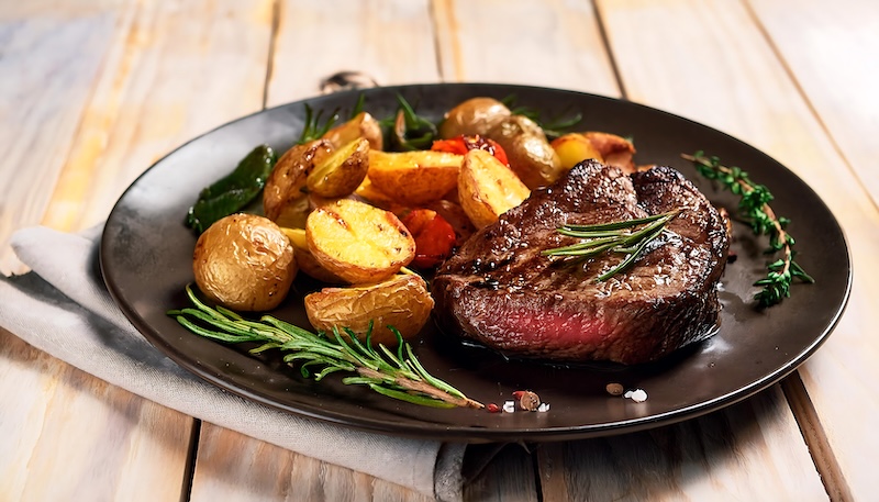 Appetizing steak and potatoes on plate