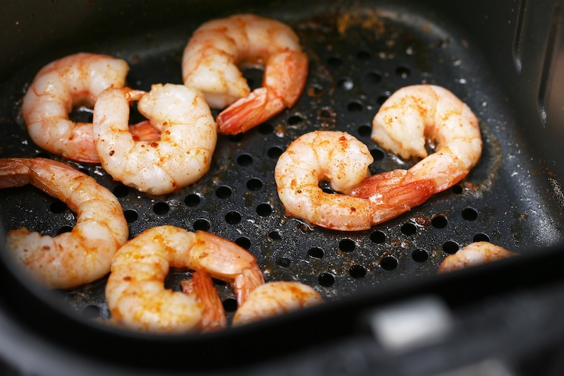 Seasoned shrimp cooked in an air fryer for a crispy result with less oil.