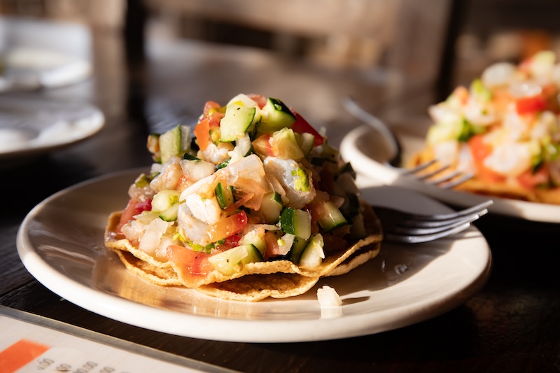 Chilled shrimp ceviche with citrus juice, tomatoes, onions, peppers and fresh herbs.
