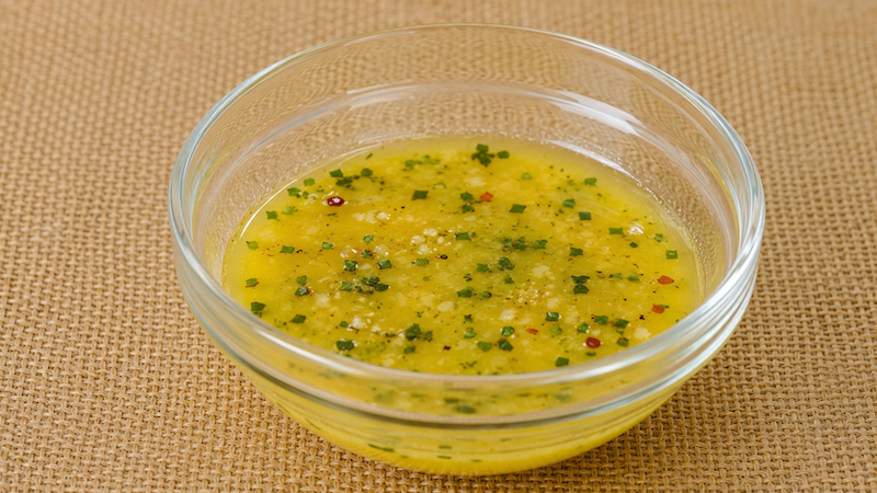 Homemade garlic butter with fresh herbs for charcoal-roasted shrimp.