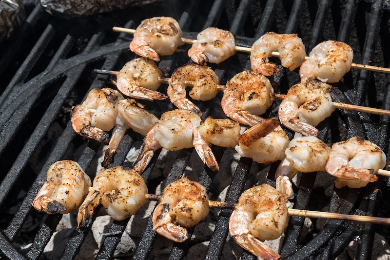 Shell-on shrimp grilling over medium-high heat for a smoky flavor.