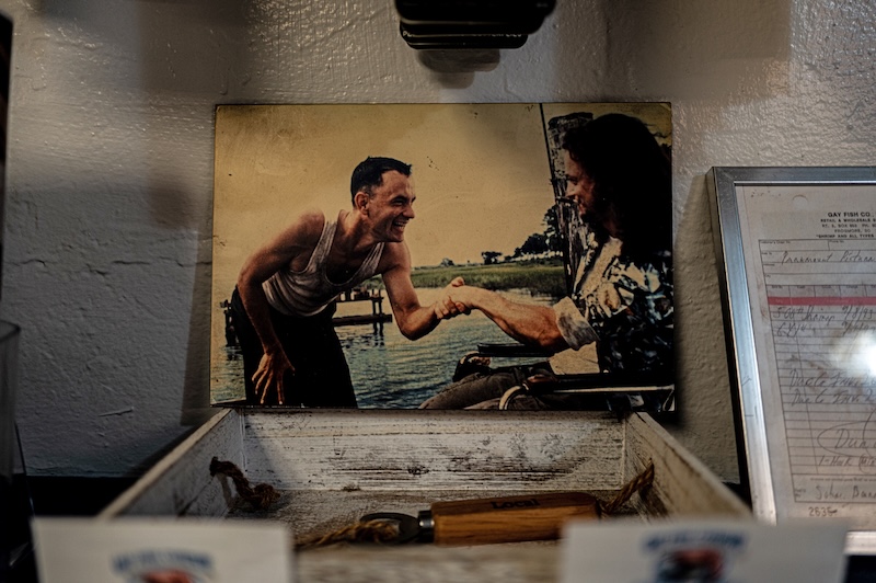 Photograph of Tom Hanks and Gary Sinise displayed at Gay Fish Company alongside memorabilia from the filming of Forrest Gump.