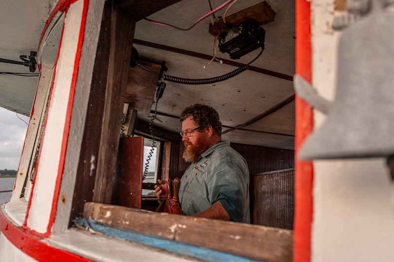 Capt. Craig Reaves and his crew setting the trawl aboard the Gracie Belle shrimp boat.