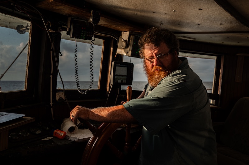 Capt. Craig Reaves at the helm of the Gracie Belle during a commercial shrimping trip.