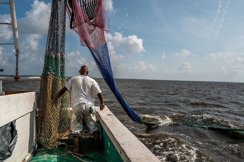 Commercial shrimping nets being lowered into the Atlantic