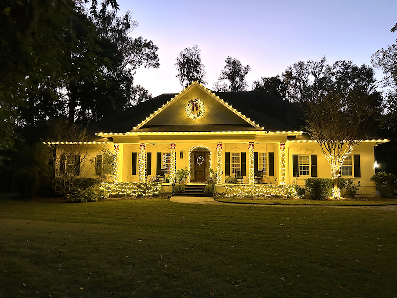 Traditional warm white Christmas lights, wreaths and garland on a Lowcountry home