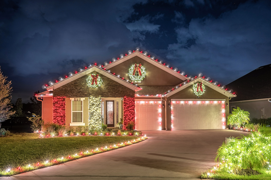 Lowcountry home decorated with red and white Christmas lights by Humbug Holiday Lighting