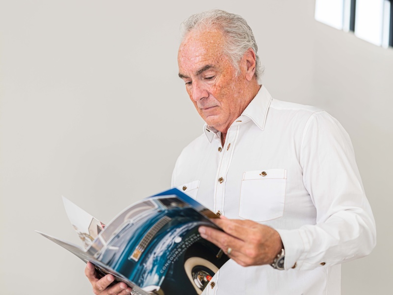 Lowcountry GT founder Steve Menzies looking through a Hilton Head Island Concours d’Elegance & Motoring Festival program.
