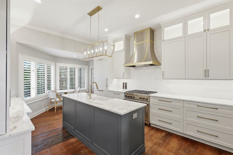 Kitchen galley renovated with vent-a-hood range hood and bright lighting