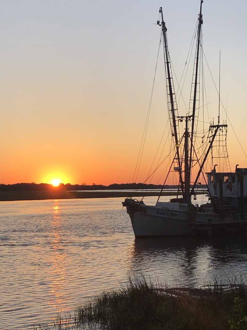 The Let’s Go shrimp boat owned by Capt. Barrett Thomas Boulware silhouetted against a Beaufort sunset.