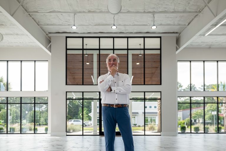 Steve Menzies standing inside the modern Lowcountry GT collector car showroom in Bluffton, South Carolina.