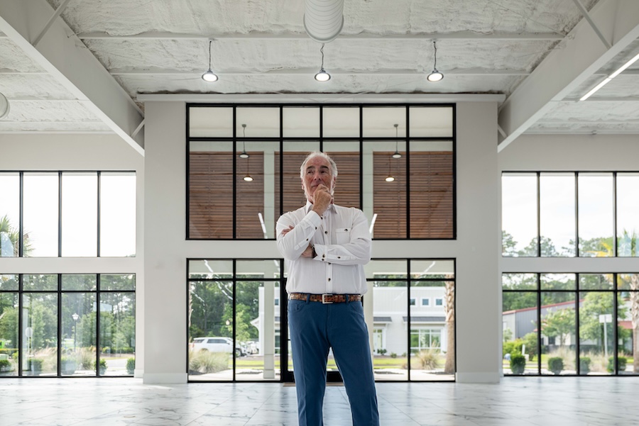 Steve Menzies standing inside the modern Lowcountry GT collector car showroom in Bluffton, South Carolina.