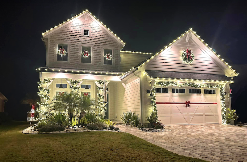Lowcountry home decorated with warm white holiday lights, wreaths and garland
