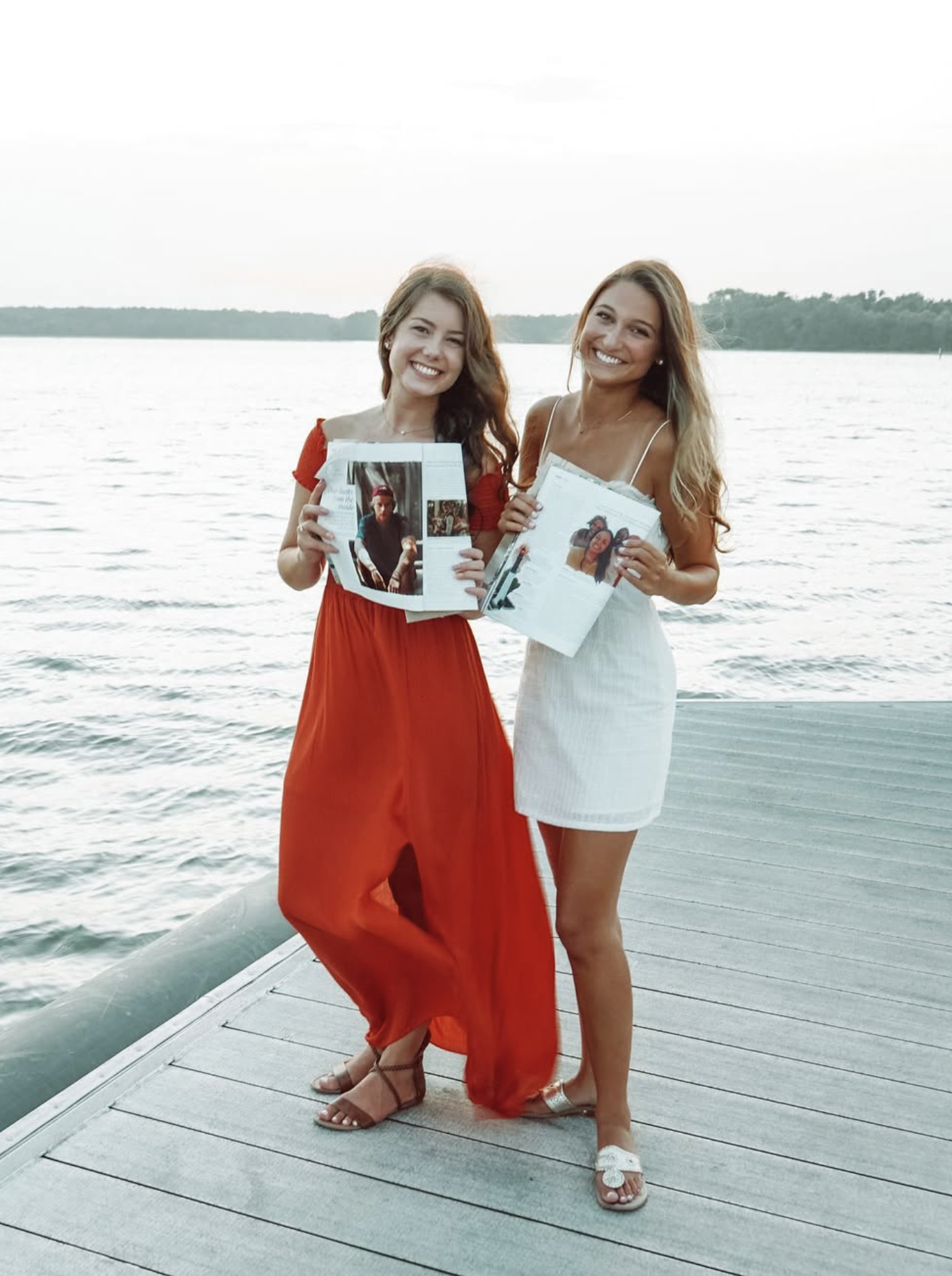 Two LOCAL Life Interns holding LOCAL Life Magazines by the water