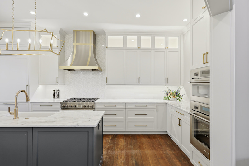 Sea Pines kitchen after renovation with improved lighting and chandelier