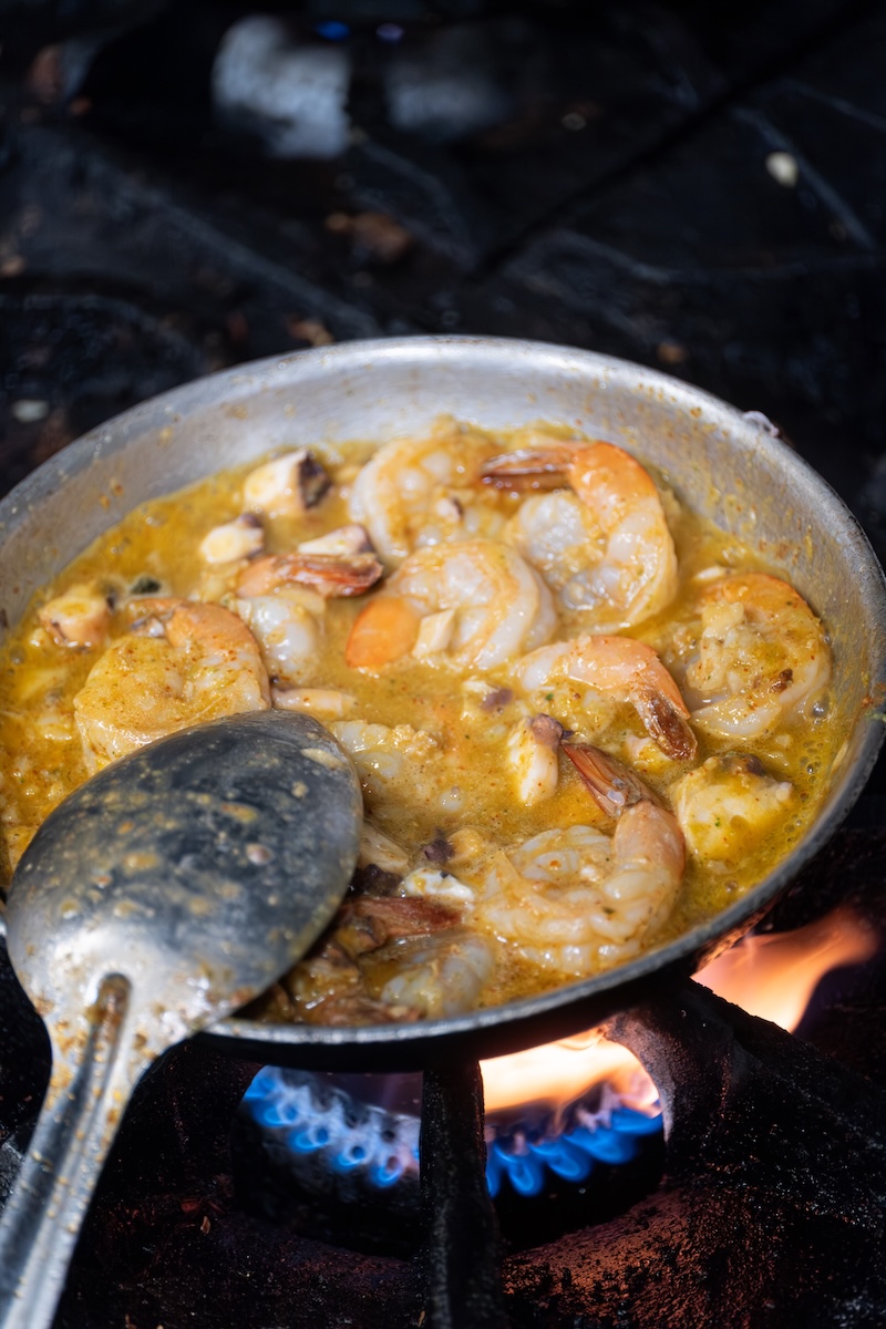 Shrimp gently simmering with butter, olive oil, garlic and white wine.