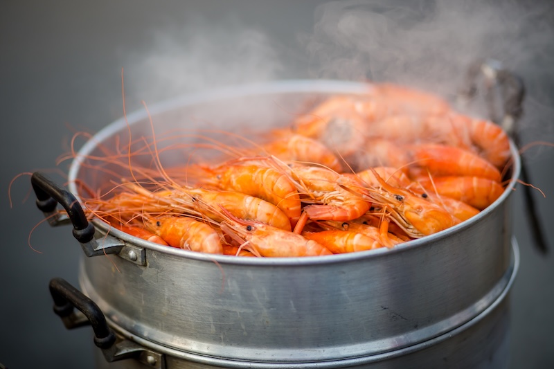 Shell-on shrimp steaming until pink and opaque for shrimp cocktail or chilled salads.
