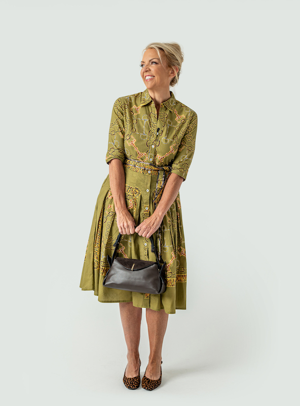 Jennifer Kenwell wearing an olive-green patterned dress with a black handbag and leopard-print shoes