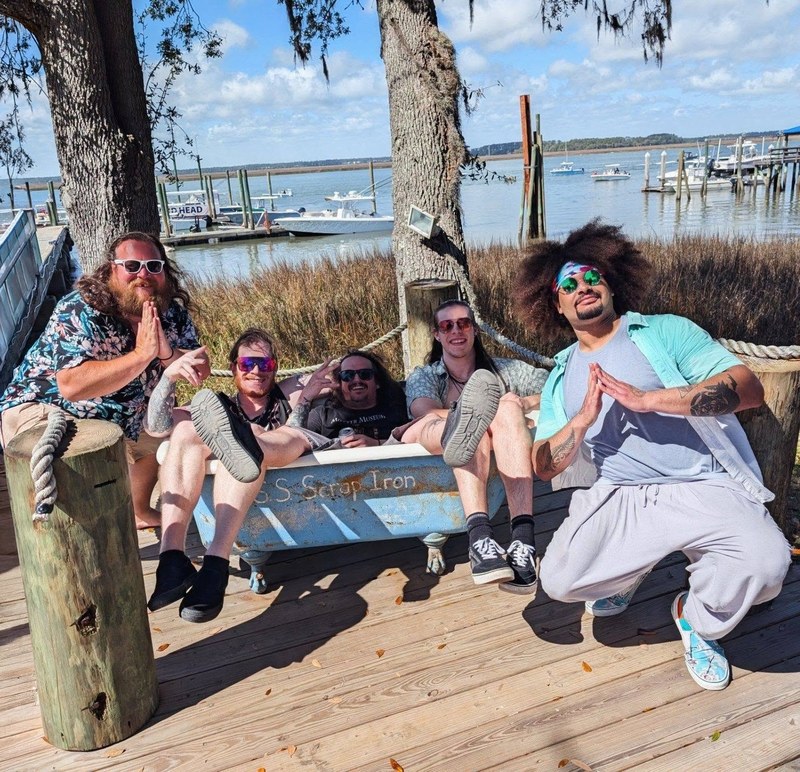 Members of Bluffton-based band Peach Patrol gathered outdoors by the water