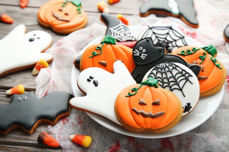 Halloween-themed cookies and baking supplies arranged on a table