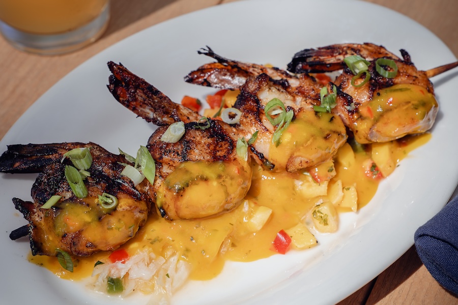 Grilled bacon-wrapped voodoo shrimp with papaya vinaigrette served over rice