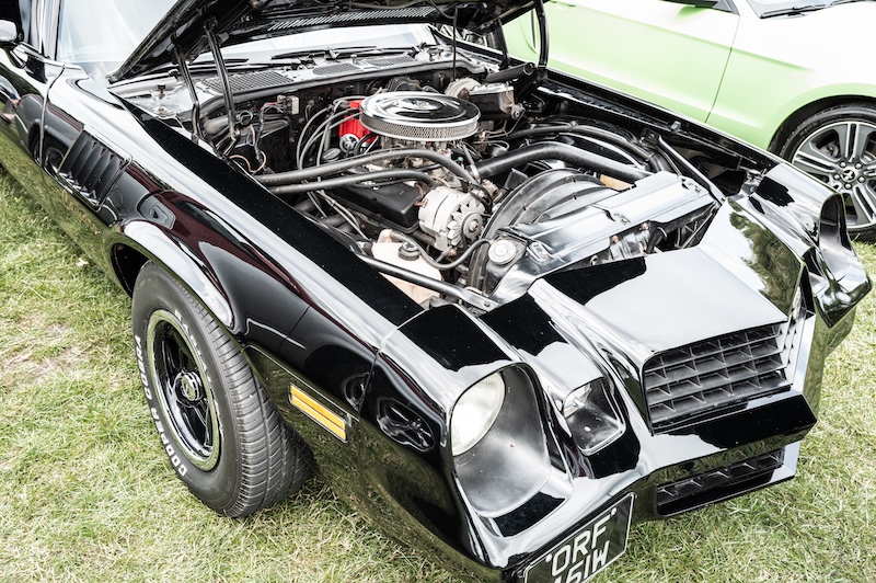 Pontiac with its hood open displaying the engine