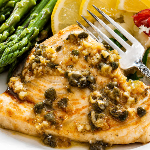 Swordfish with lemon-caper sauce served with asparagus