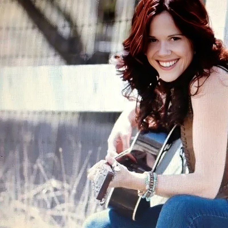 Musician Julie Gribble performing with an acoustic guitar