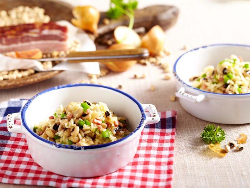 Bowl of Hoppin’ John on a red-and-white checked tablecloth