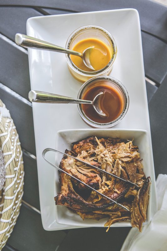 Pulled pork with serving utensils and sauces
