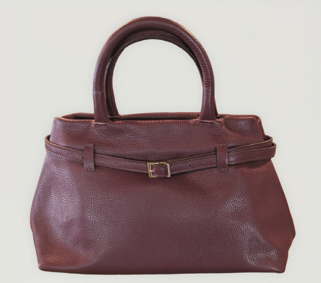 Structured burgundy leather handbag with rounded handles and belted detailing