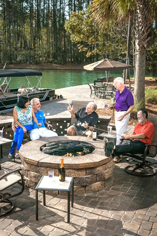 Guests gathered around a backyard fire pit at Hampton Lake
