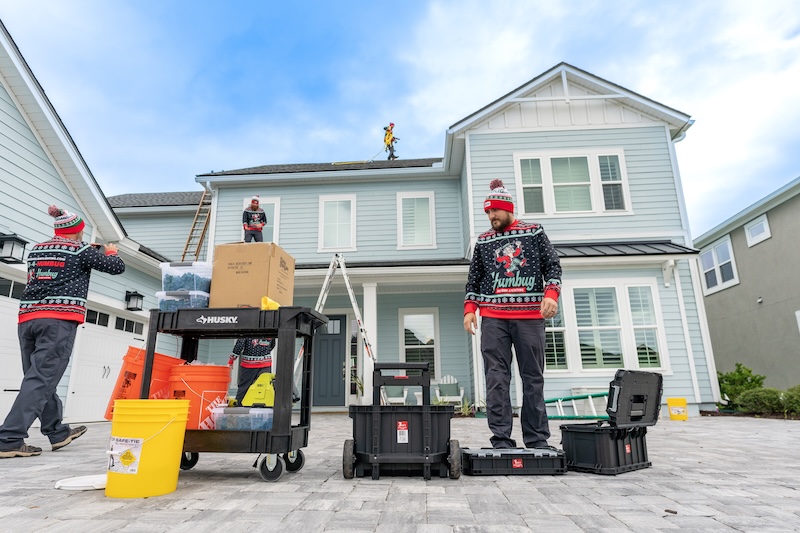 Humbug Holiday Lighting crew prepares ladders, lighting supplies and equipment outside a residential home.