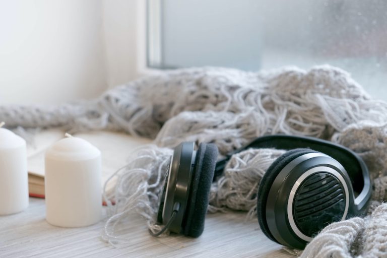 Black over-ear headphones resting on a soft fabric surface